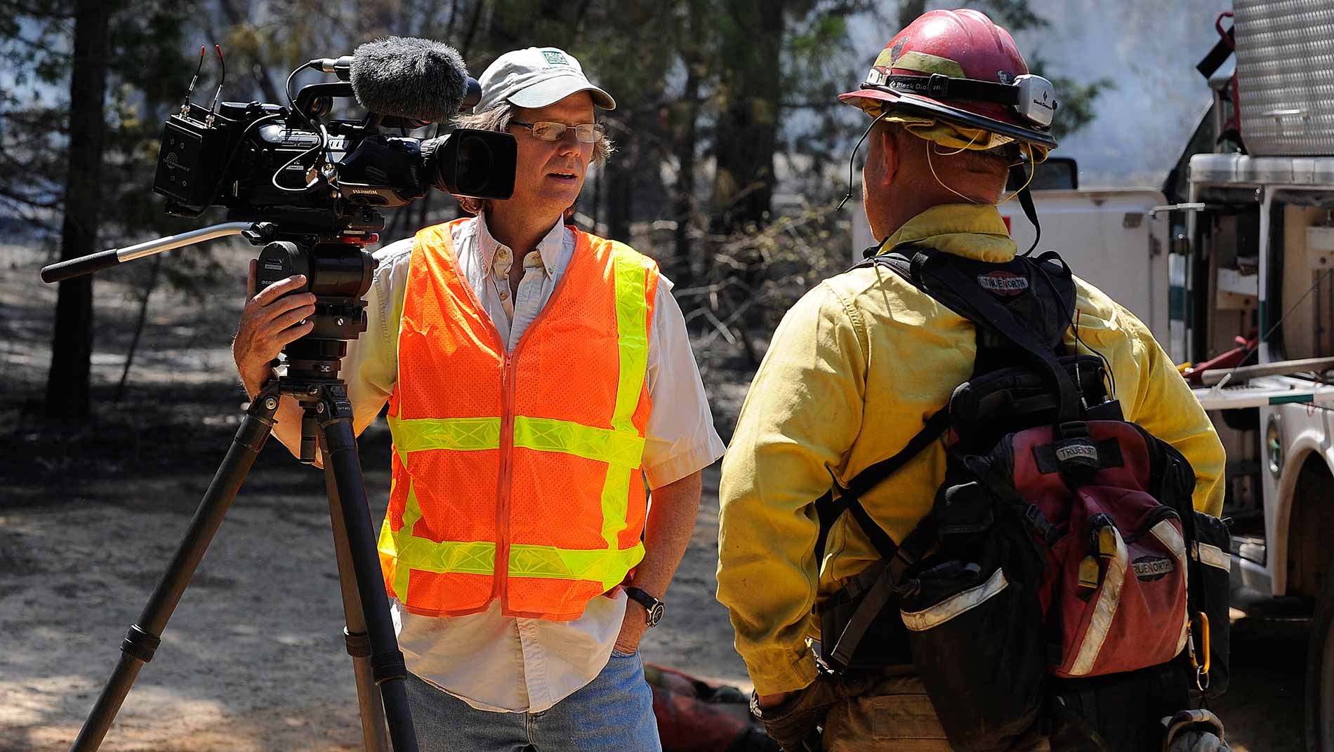 Producer Don Cash interviews a member of the Wildland Fire Team after the Bastrop State Park fire.